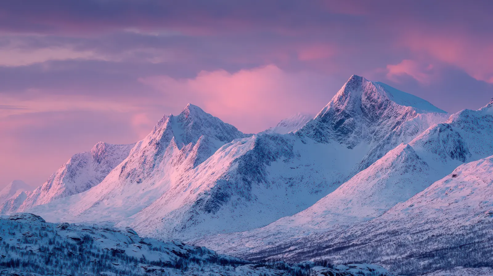 Snow-capped peaks under a pink and violet sunrise, for Numminen Advisory funding and due diligence readiness